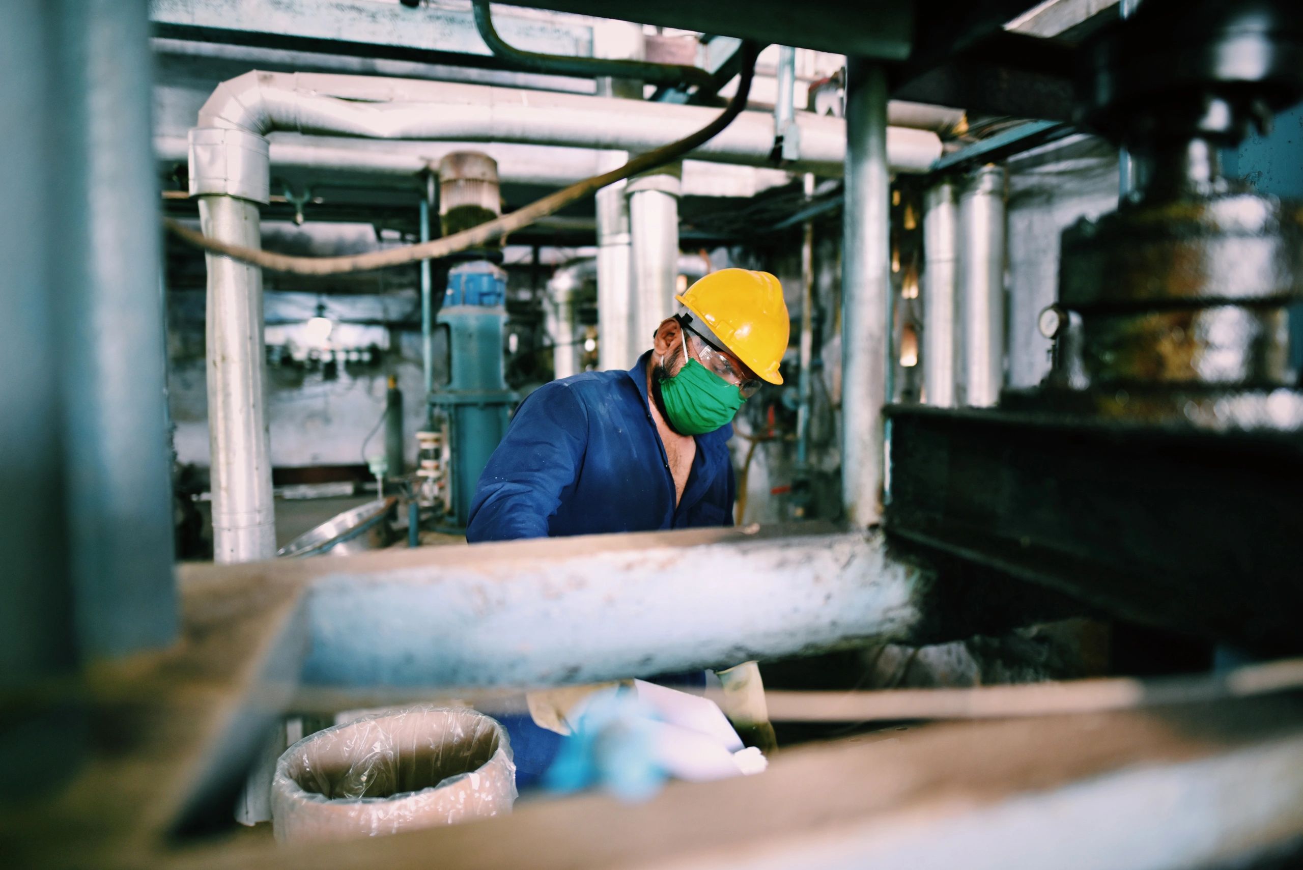 Industrial worker in safety gear at a chemical plant
