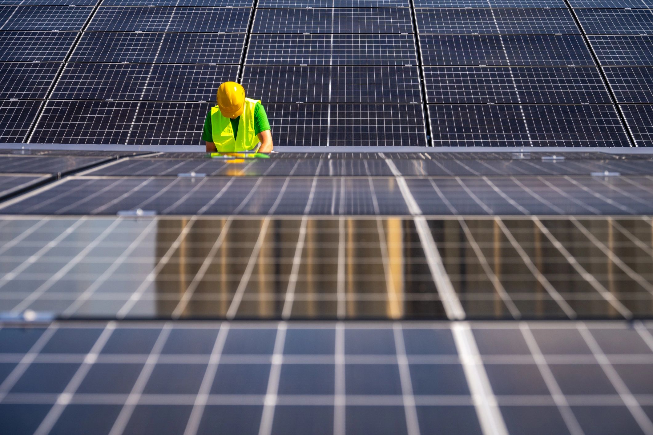 Technician inspecting solar panels