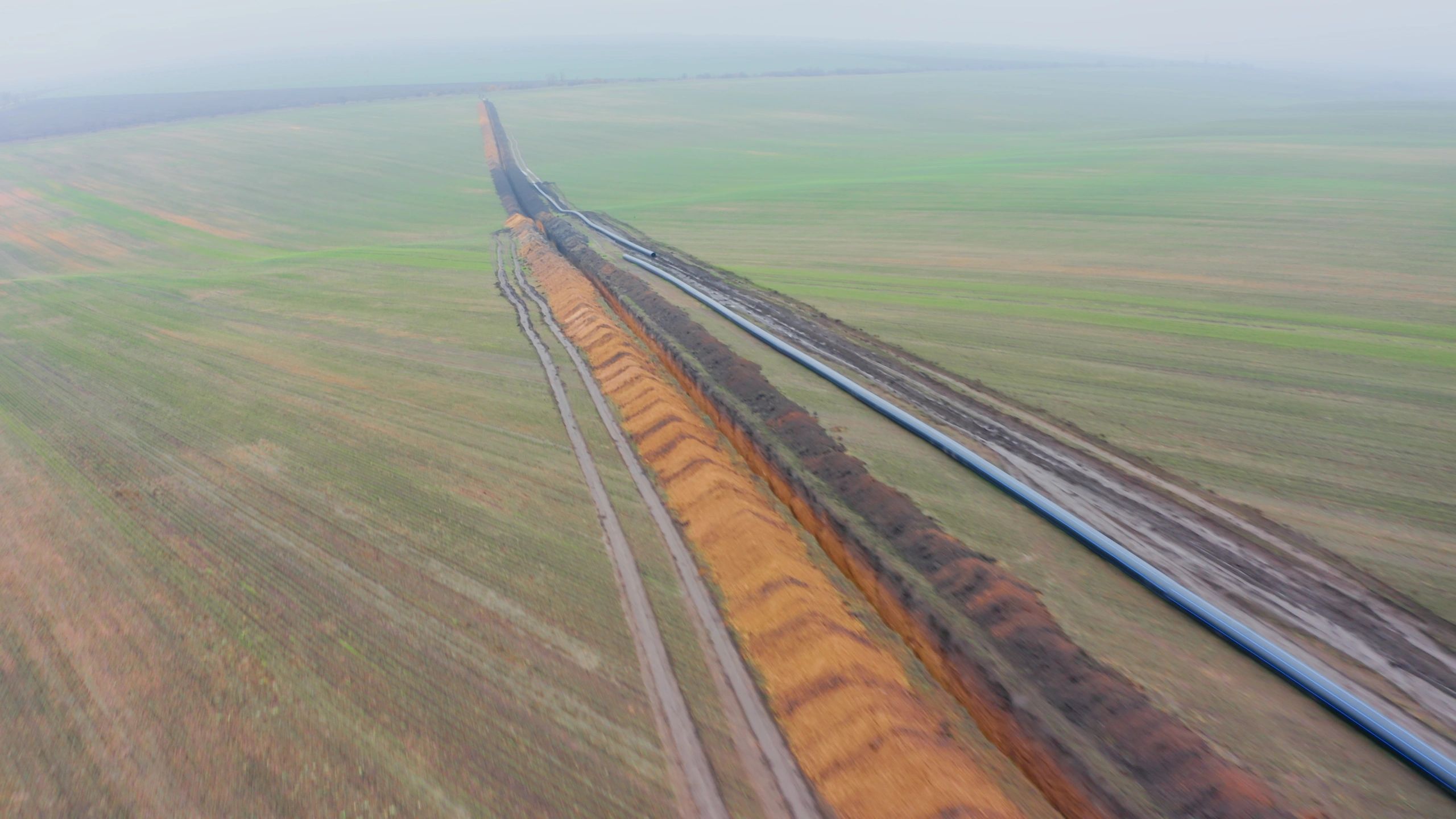 Pipeline construction trench across farmland