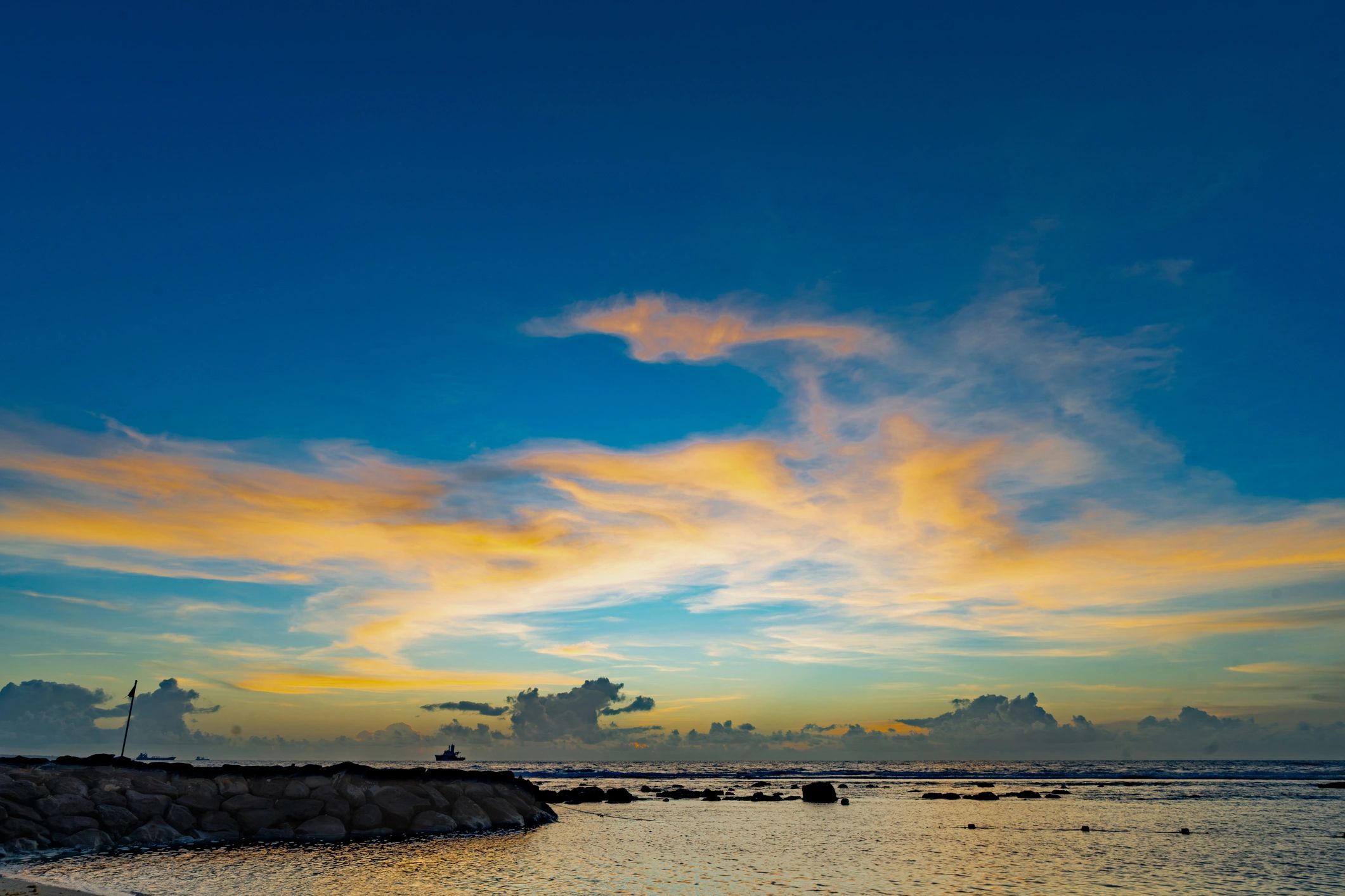 Offshore wind turbine at sunset