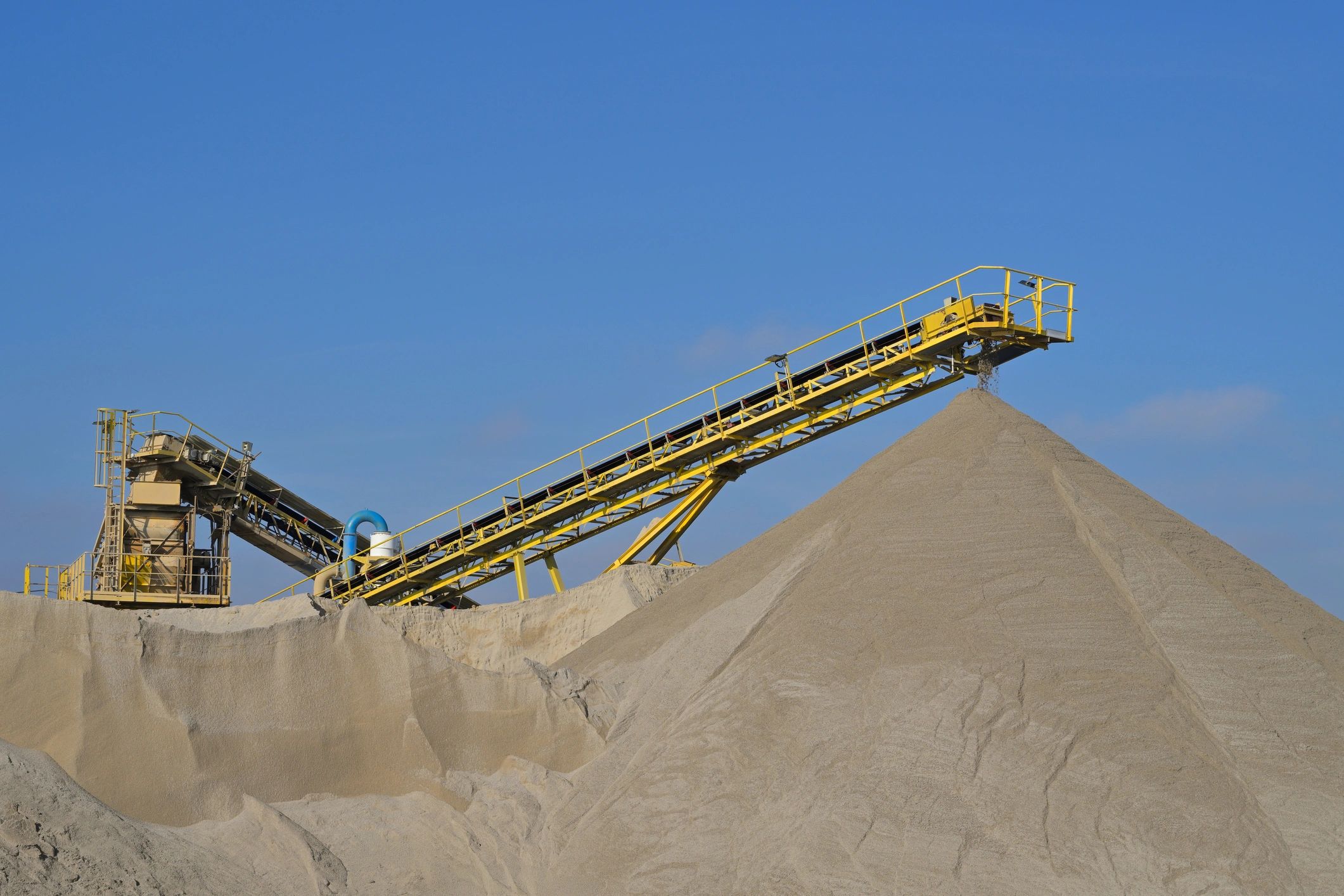 Conveyor belt creating large sand pile in quarry