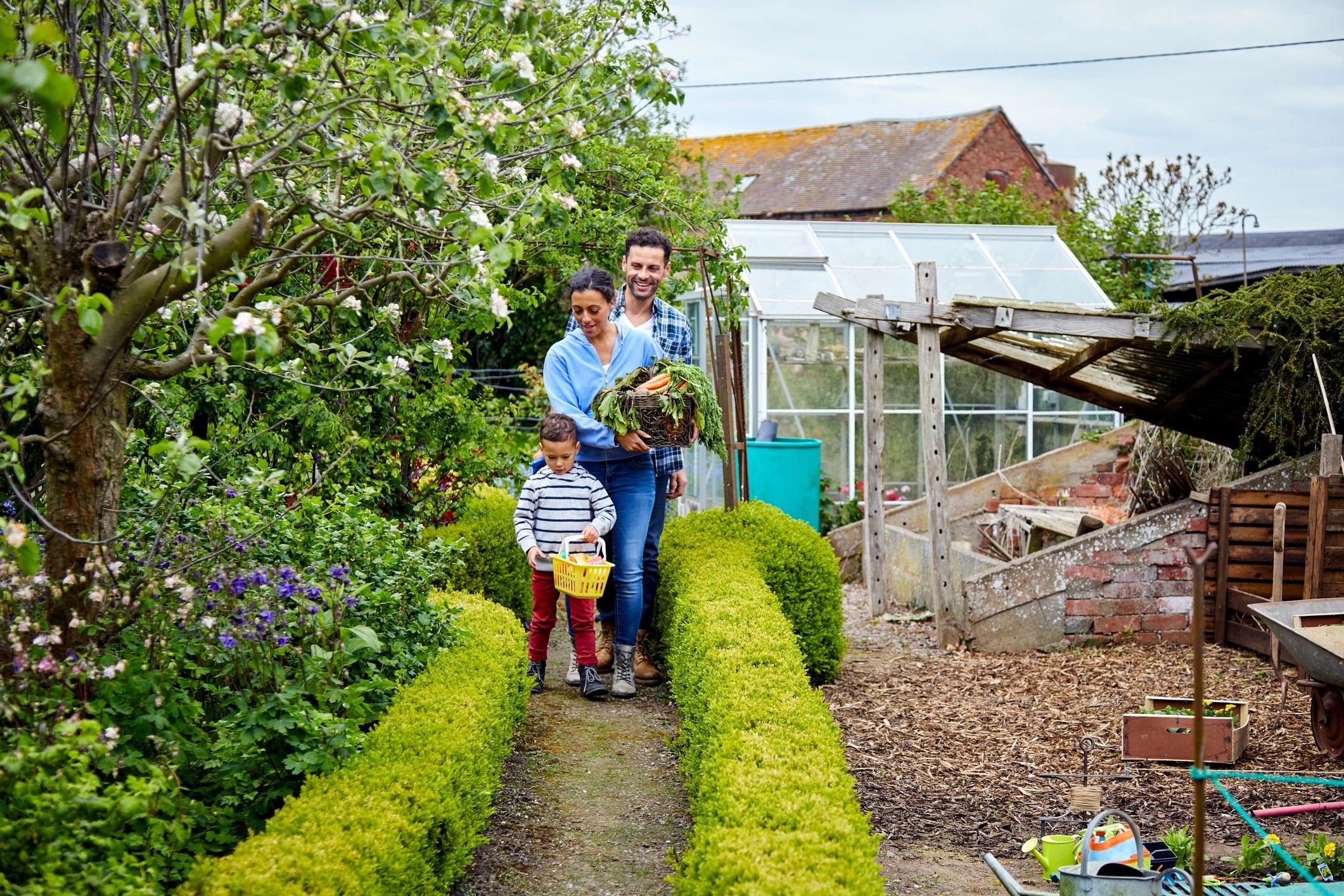 Family on a farm with harvested vegetables, representing responsible agriculture