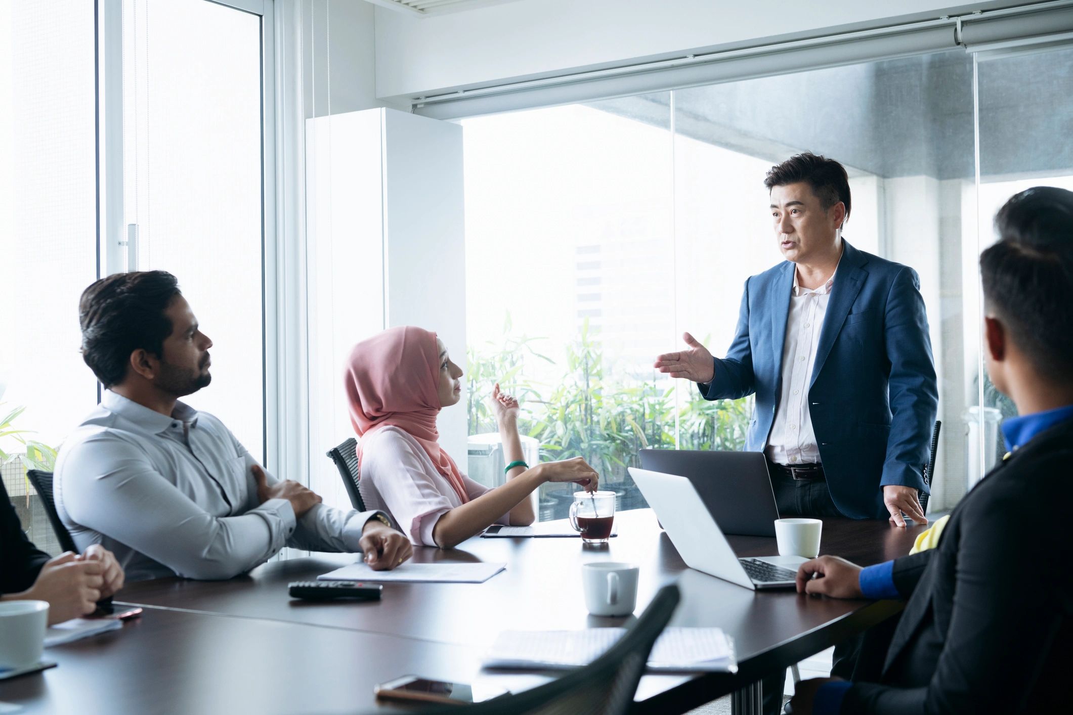 Mature businessman in meeting with colleagues